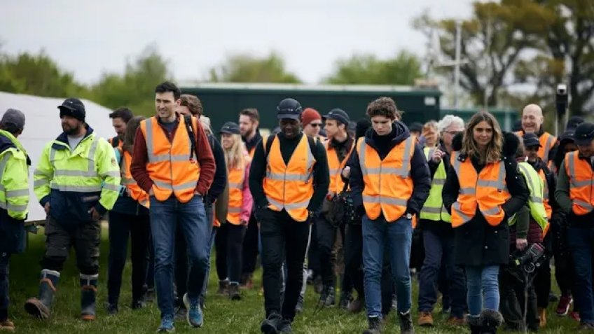 group of people in high visibility gear walking 