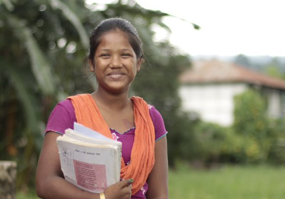 Woman smiling and holding books