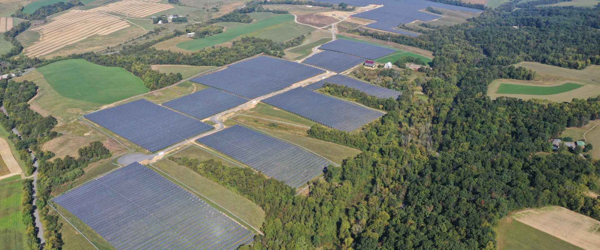 Aerial image of rows of solar panels on a solar farm