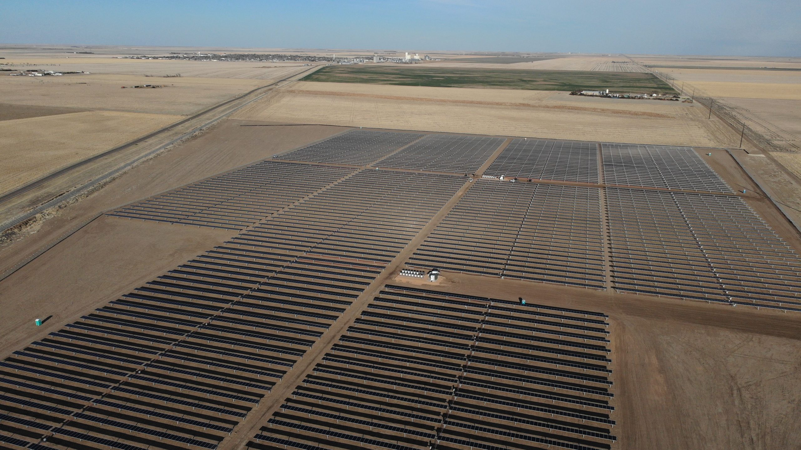 Aerial image of rows of solar panels on a solar farm