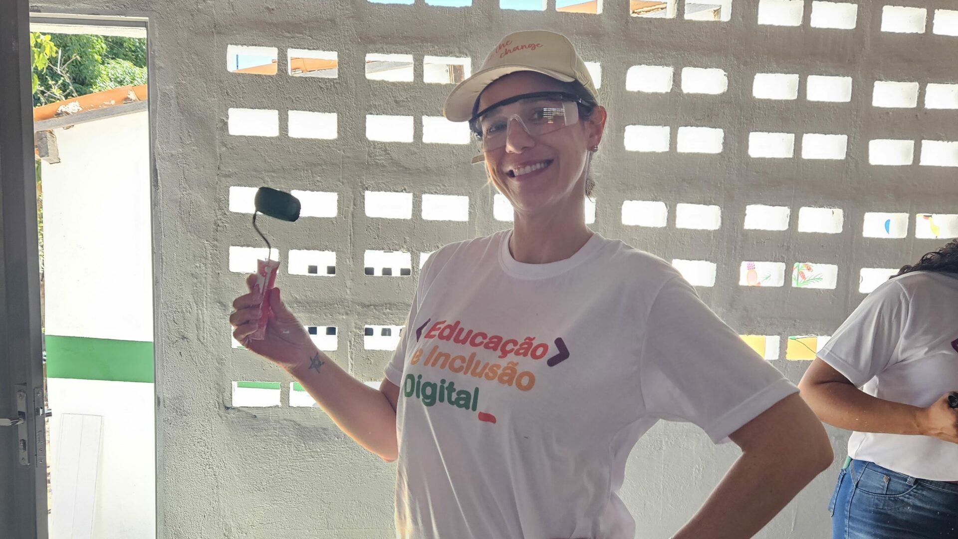 Brazil team volunteer smiling with paint roller