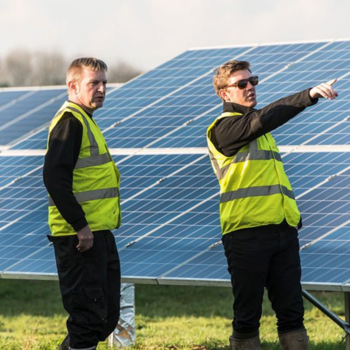 men in hi-viz on solar site