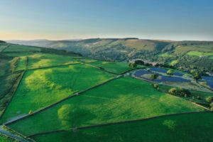 aerial shot of a solar farm  surrounded by the countryside