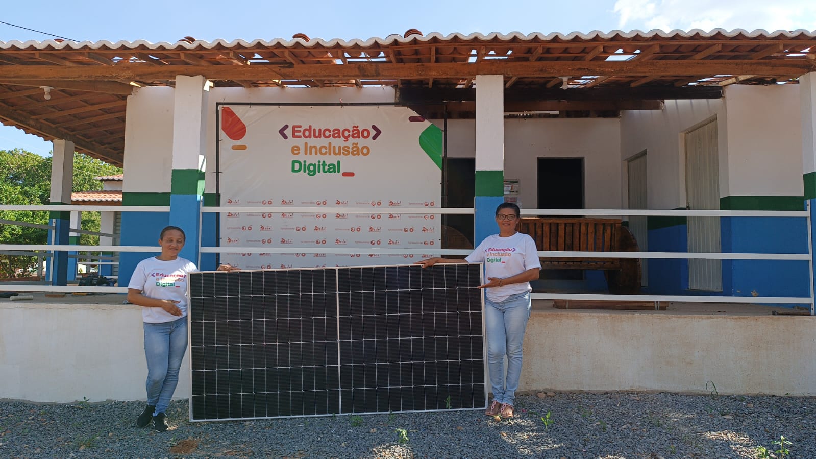 School teachers with new solar panels for the school