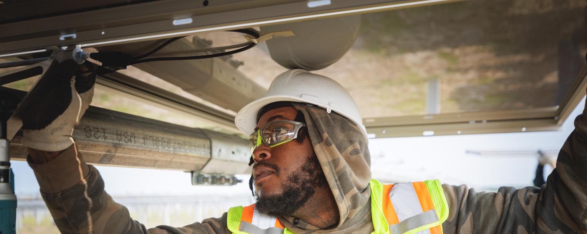 Construction worker working on a solar panel