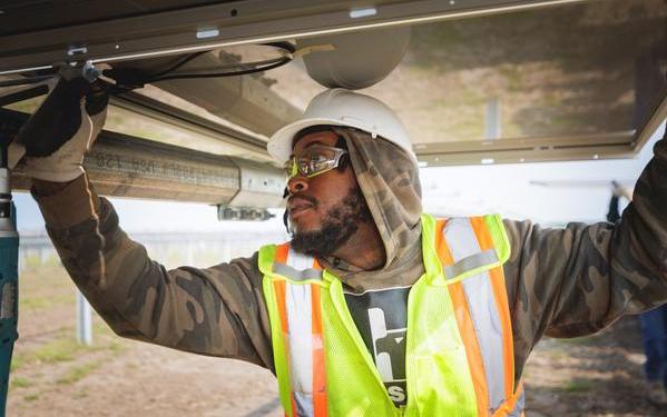 Construction worker working on a solar panel